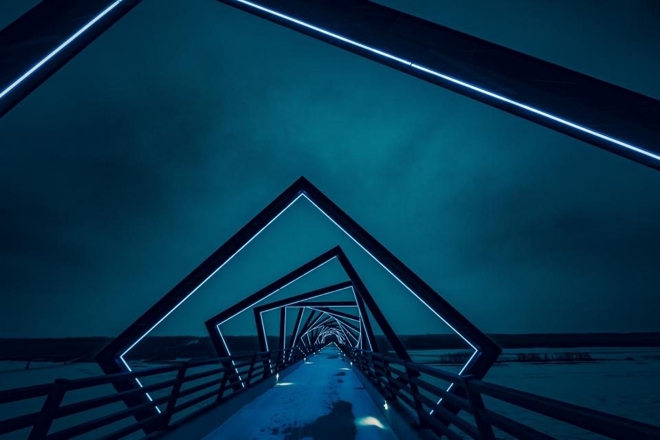 Geometric bridge structure lit in blue