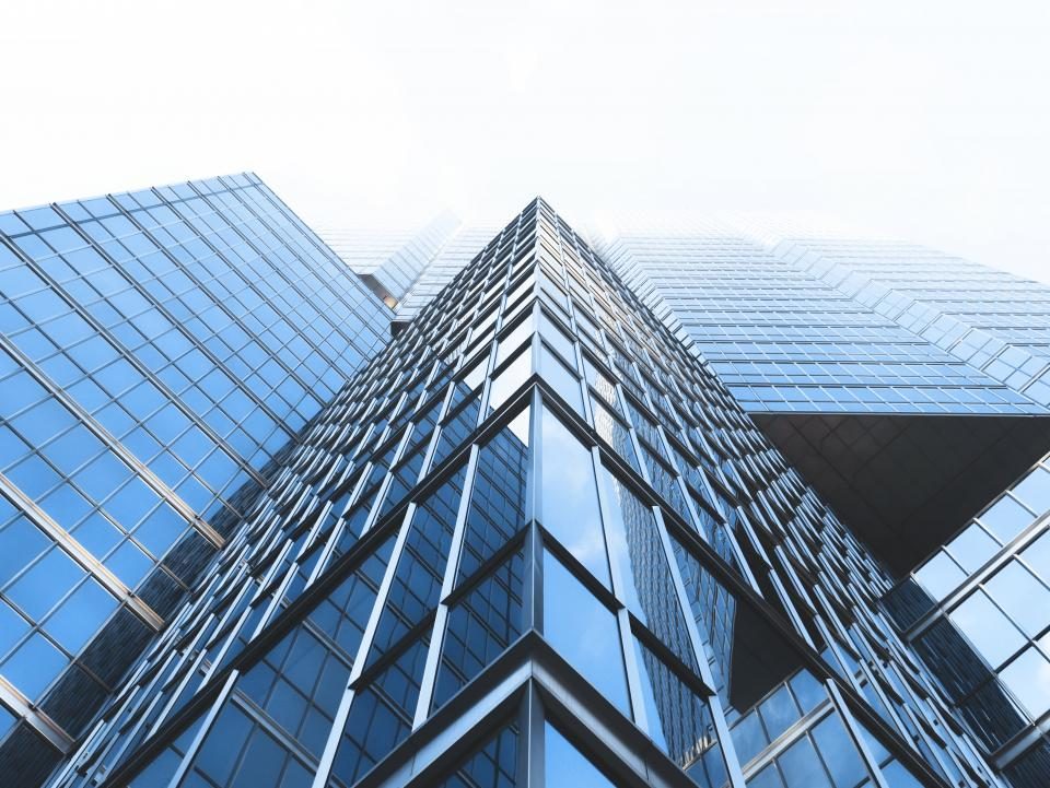 Glass skyscraper against a blue sky