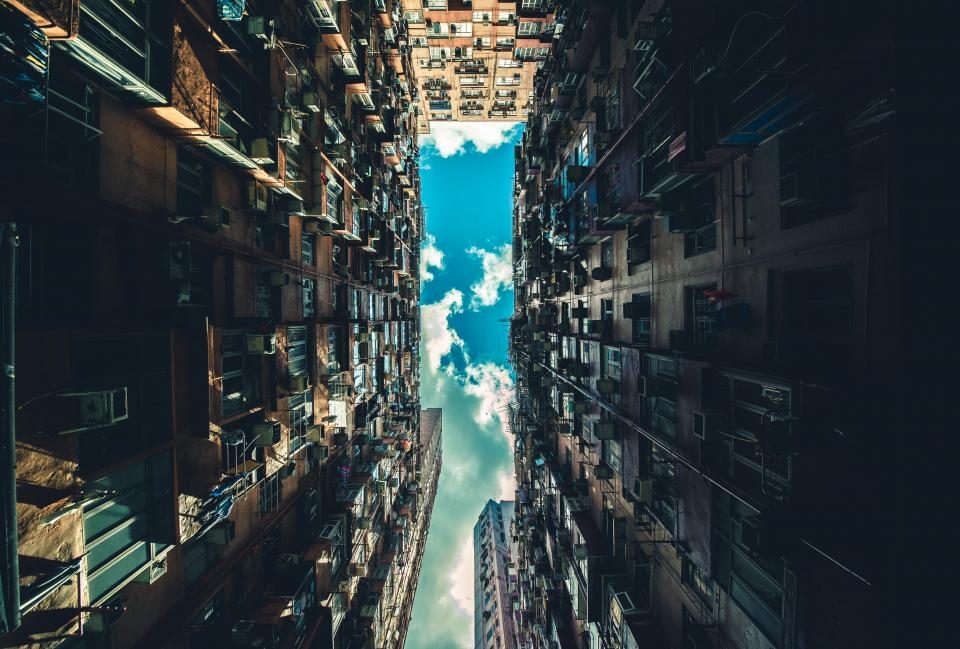 Looking up between buildings at the sky