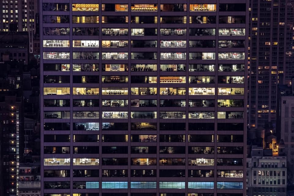 Office building windows lit up at night