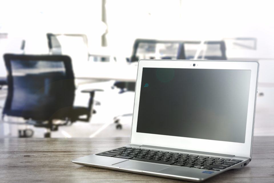 Laptop on a desk in an open office