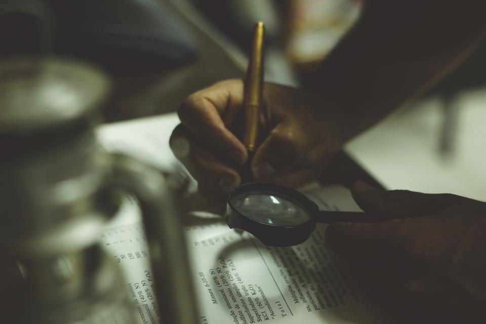 Hand writing in a book in low light