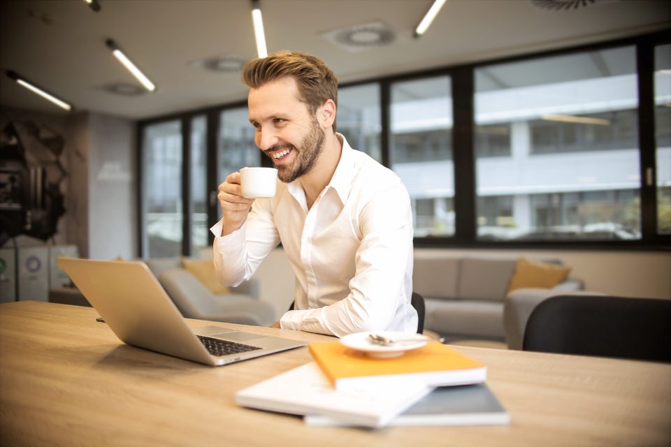 Smiling man working at a laptop