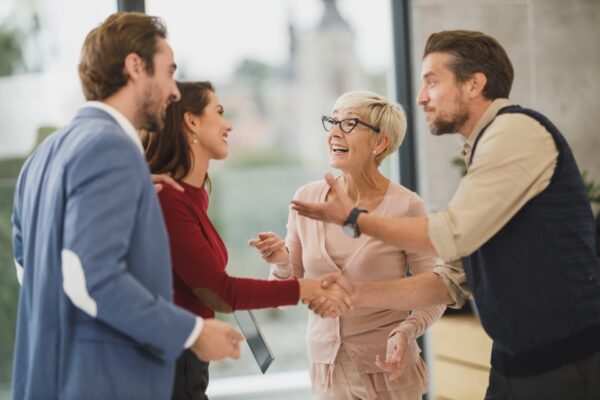 People greeting each other with a handshake in an office