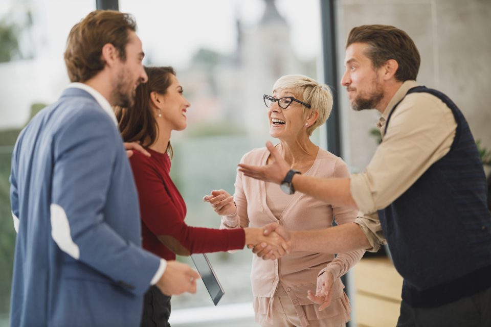 People greeting each other with a handshake in an office