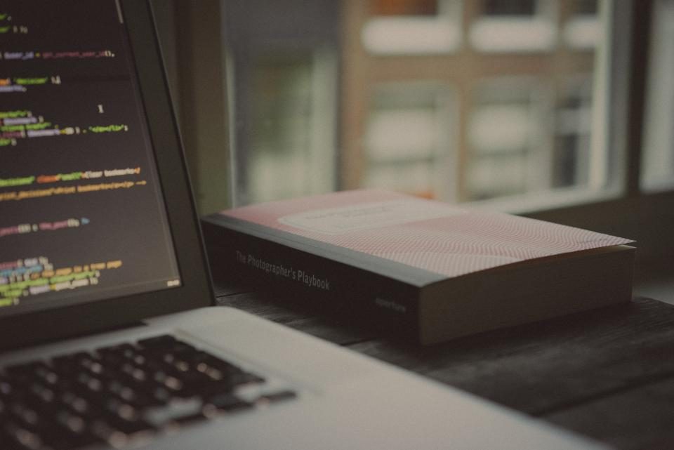 Laptop showing code beside a box