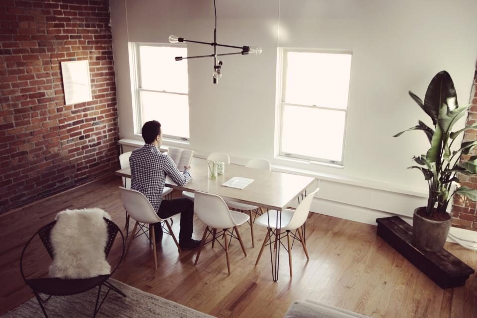 Man sitting at a table in a bright room