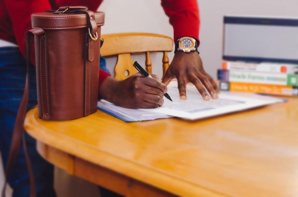 Man signing documents at a desk