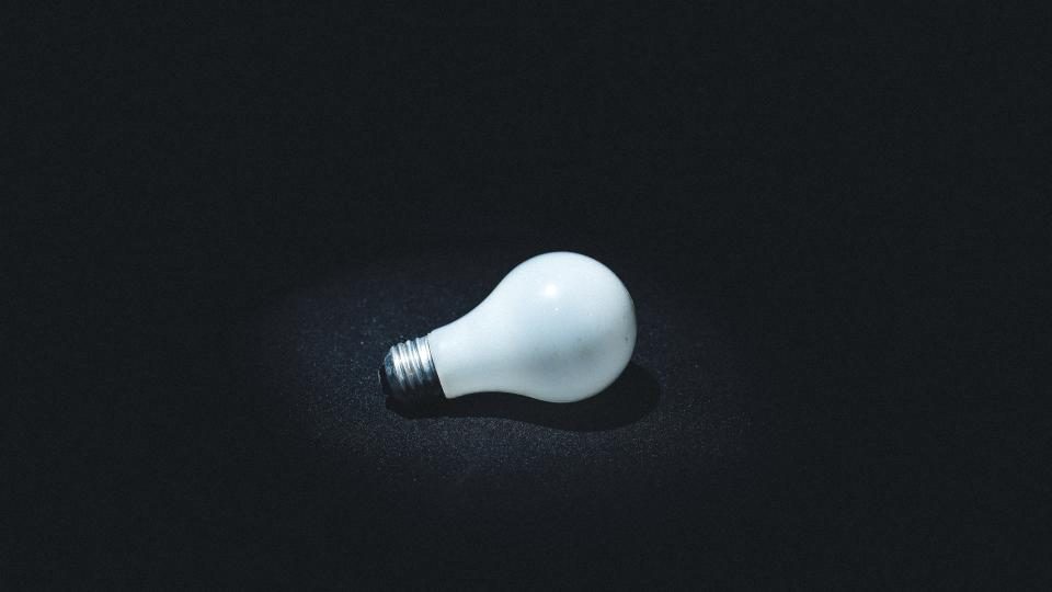 Light bulb on a dark surface