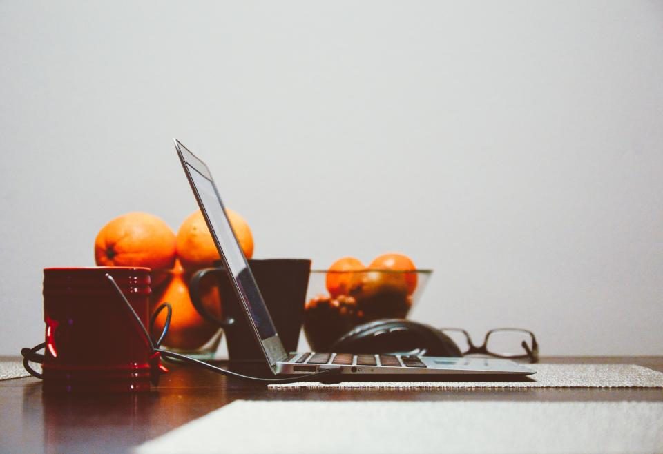 Laptop, glasses and oranges on a desk