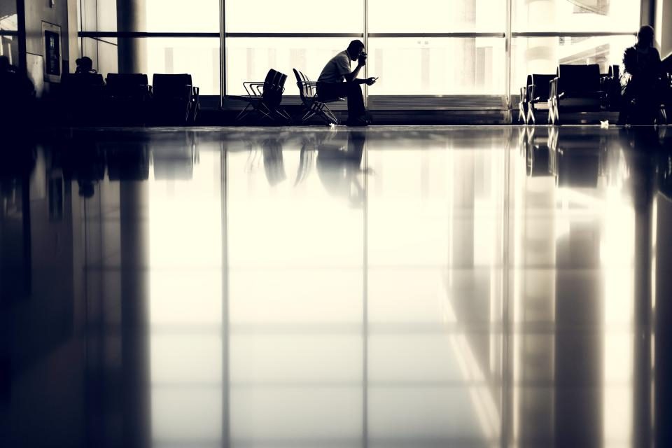 Silhouette of a person in a large office