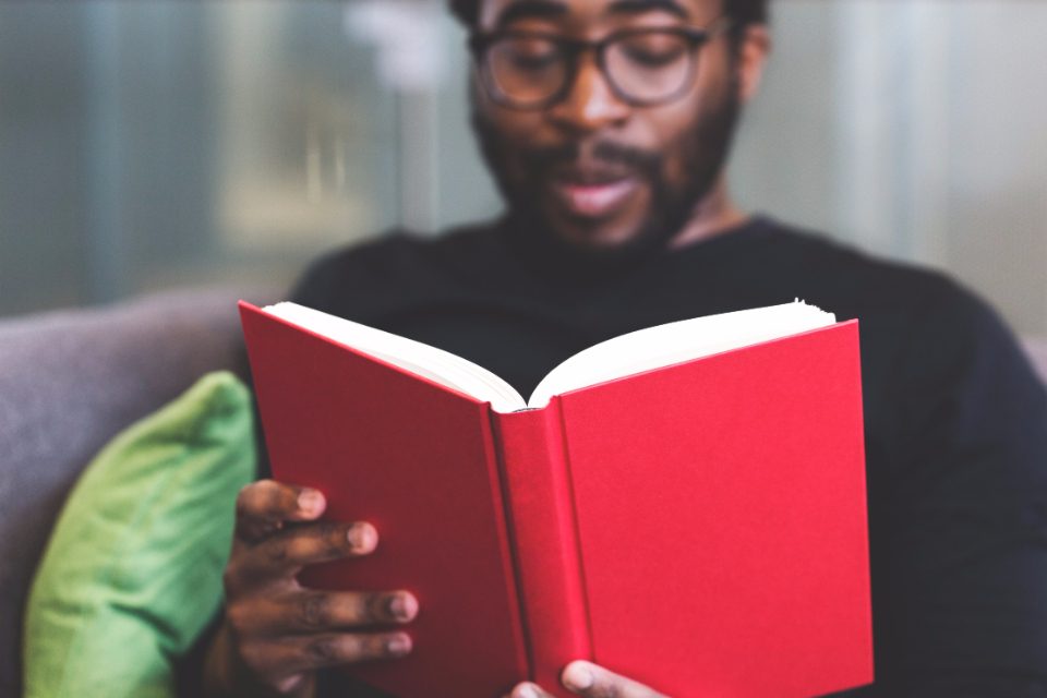 Man reading a red book