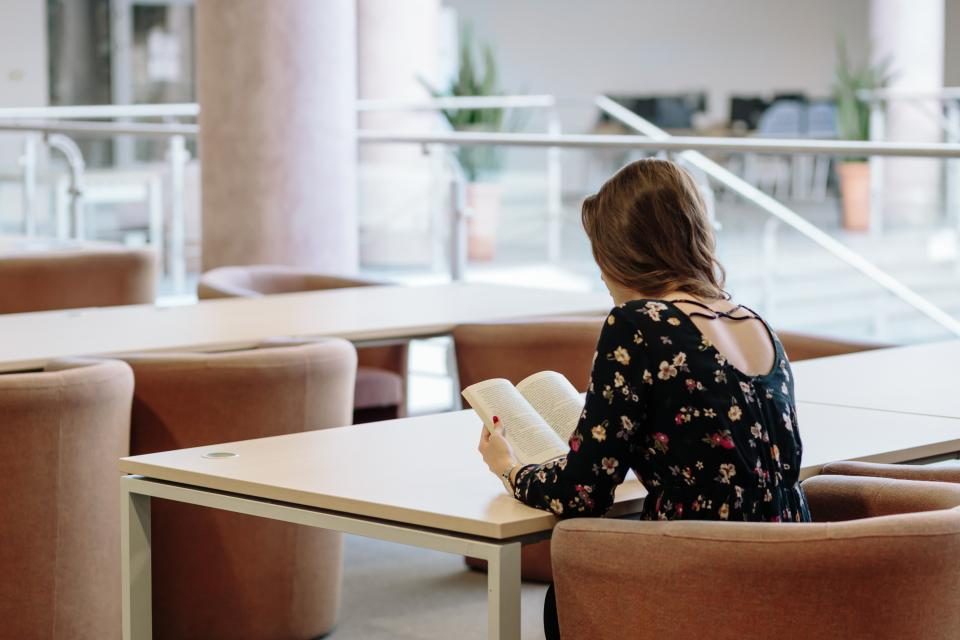 Woman reading in a bright study area