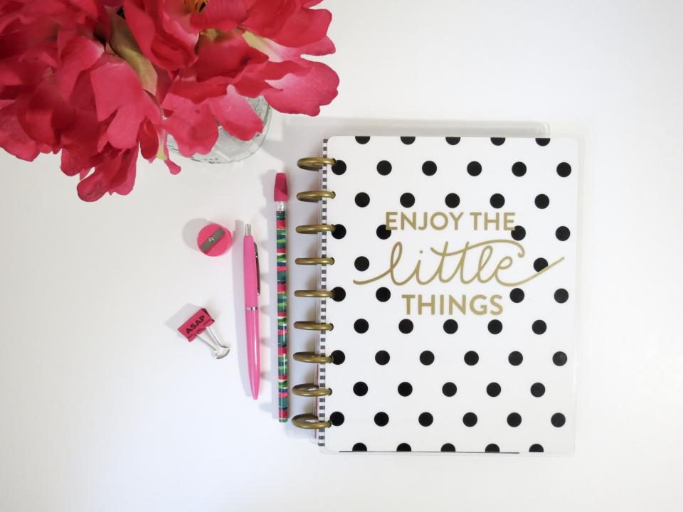Notebook with flowers on a desk