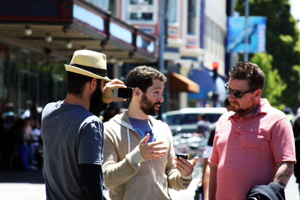 Three men talking on a city street