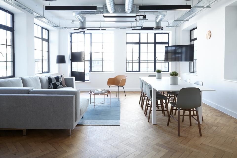 Bright, modern open-plan office with a meeting table
