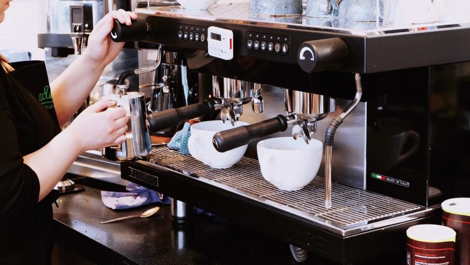 Barista making coffee at an espresso machine