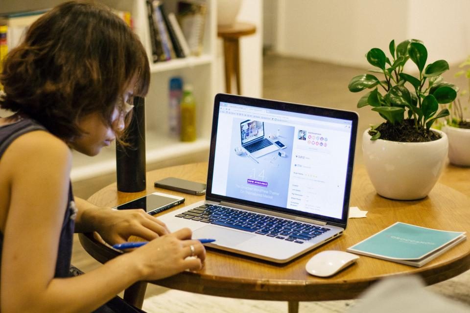 Woman working on a laptop at home
