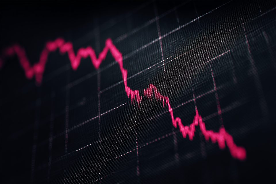 Falling stock market chart on a dark screen