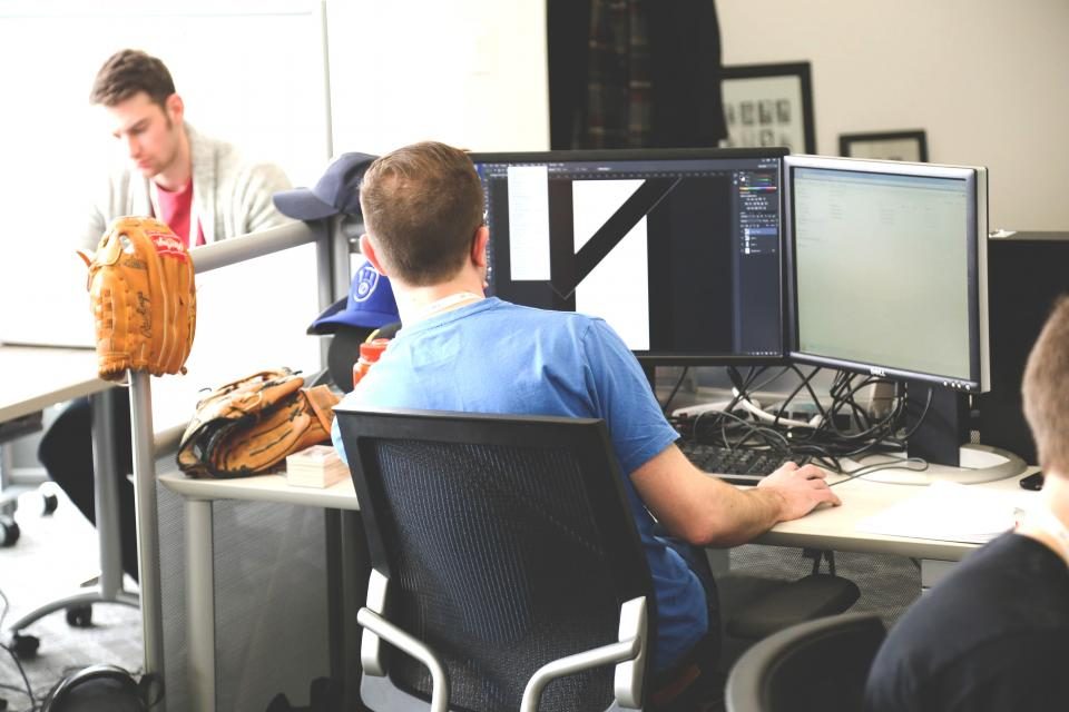 Colleagues working at computers in an office