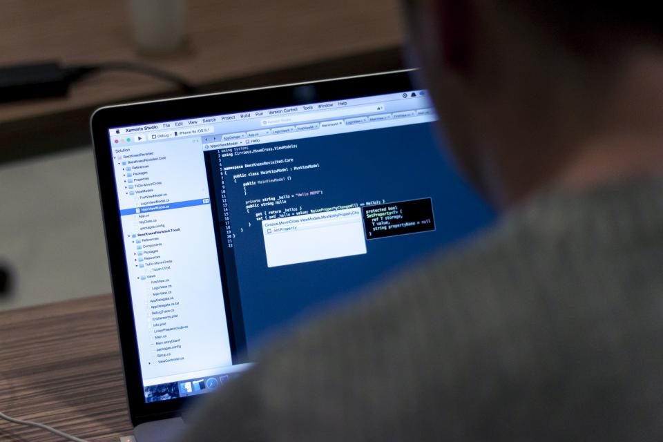 Person working on code at a laptop