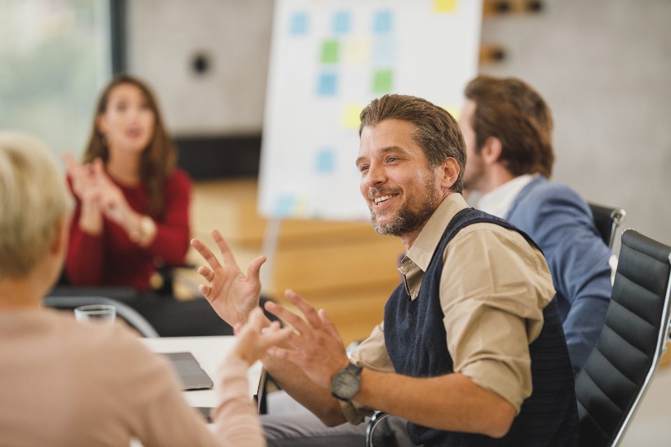 Meeting by a flipchart covered in sticky notes