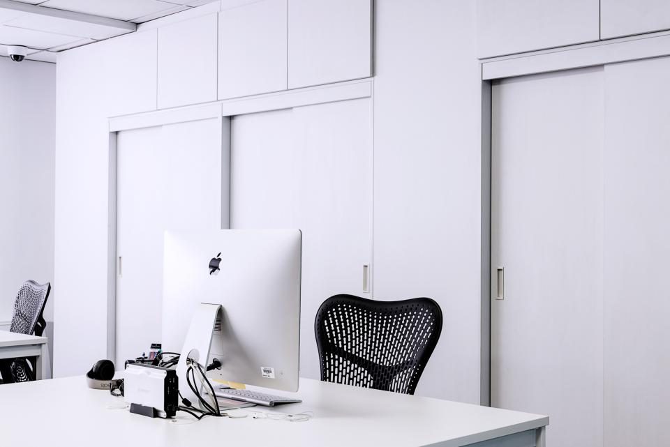 Computer on a white desk in a bright office
