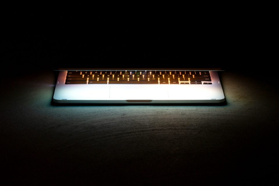 Laptop keyboard glowing in the dark