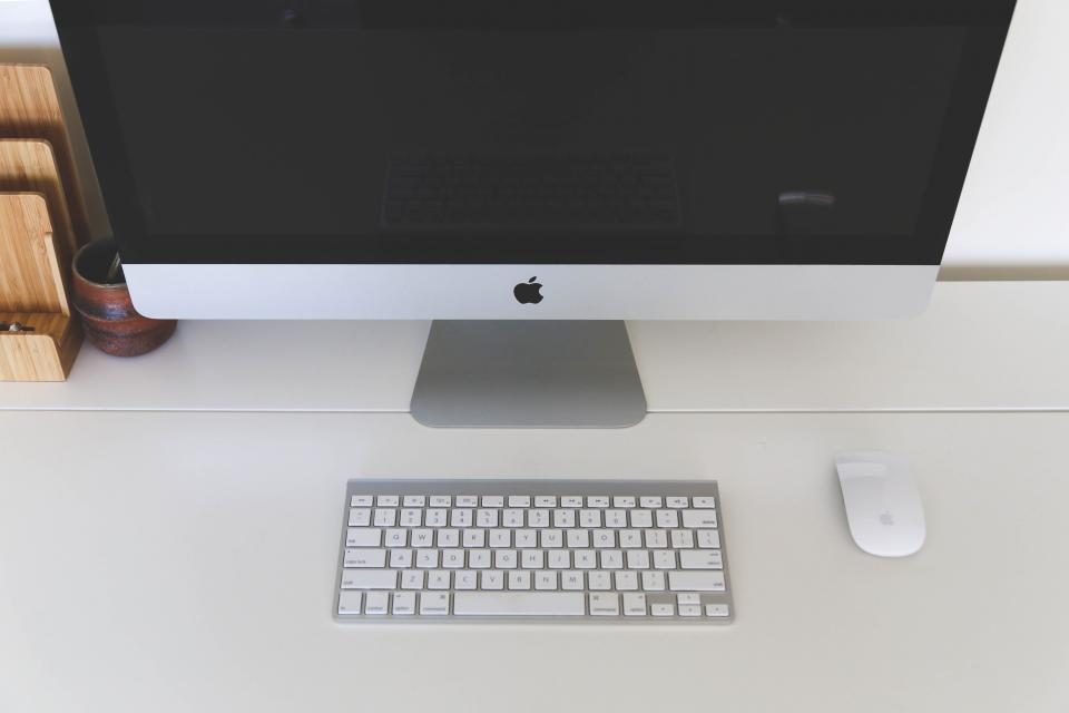 Desktop computer and keyboard on a white desk