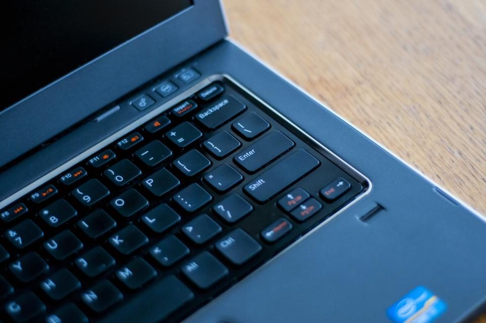 Laptop keyboard on a wooden table