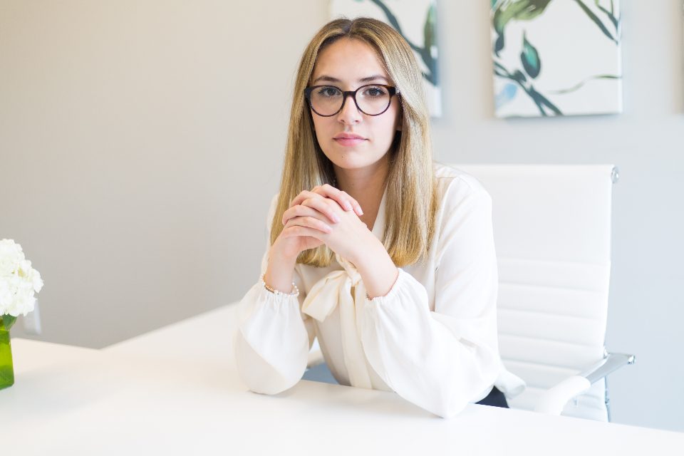 Young woman sitting at a white desk