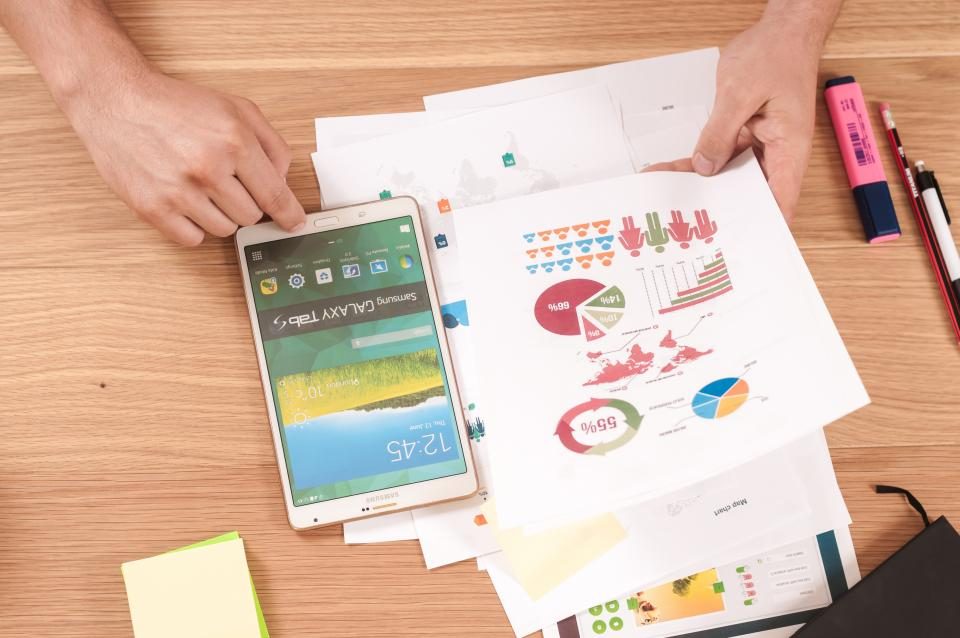 Phone and printed charts on a desk