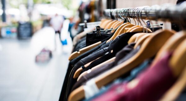 Clothing on hangers on a rail in a retail store