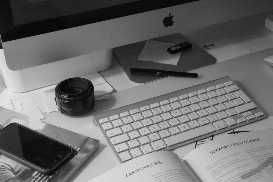 Desk with a computer keyboard, phone and notes