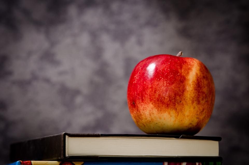 Red apple on a stack of books