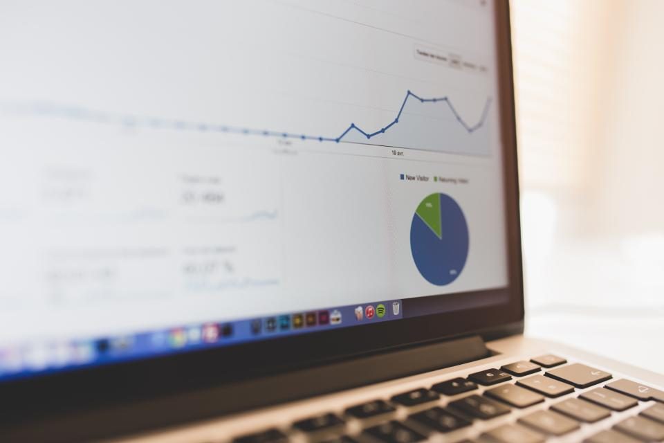 Laptop showing a line chart and a pie chart