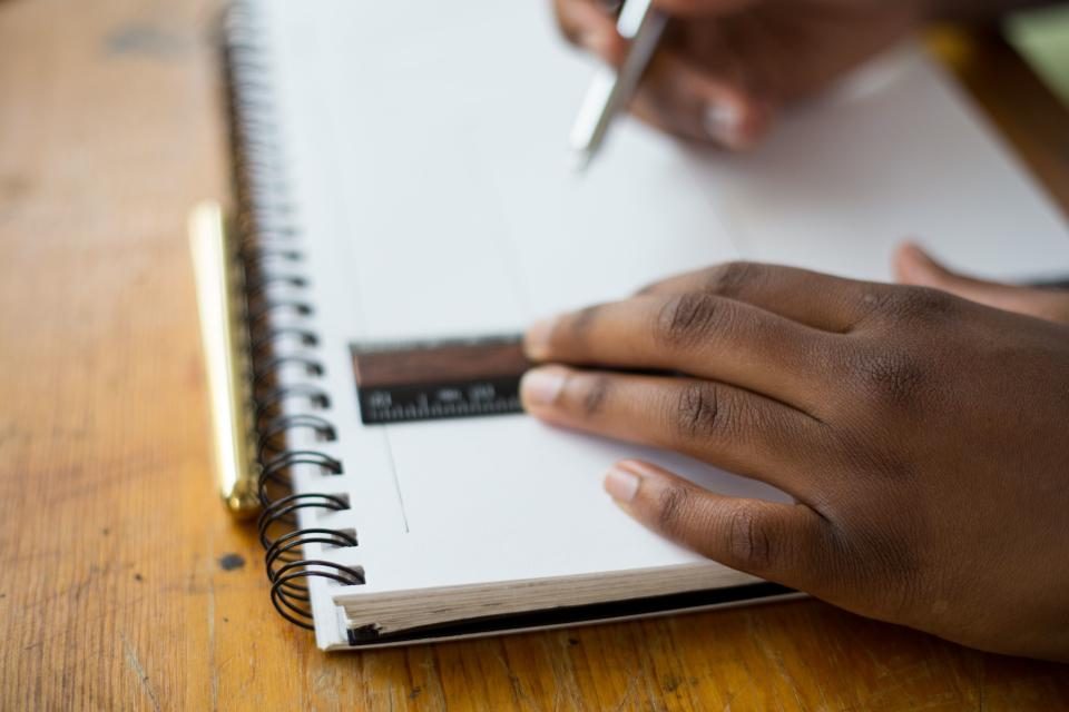 Hand writing on a spiral notepad