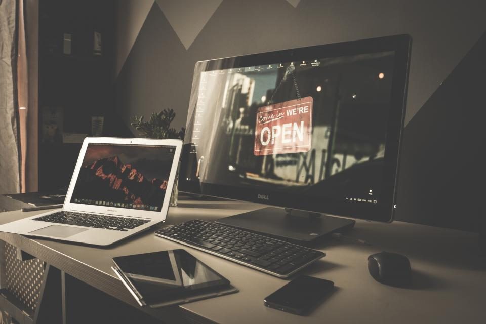 Laptop and desktop screen in a dark room