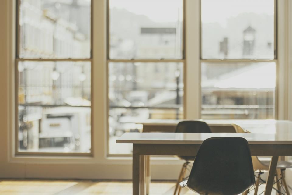 Meeting table by large office windows