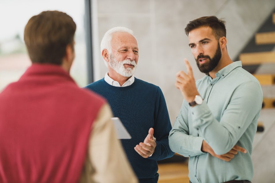 Colleagues talking face to face in an office