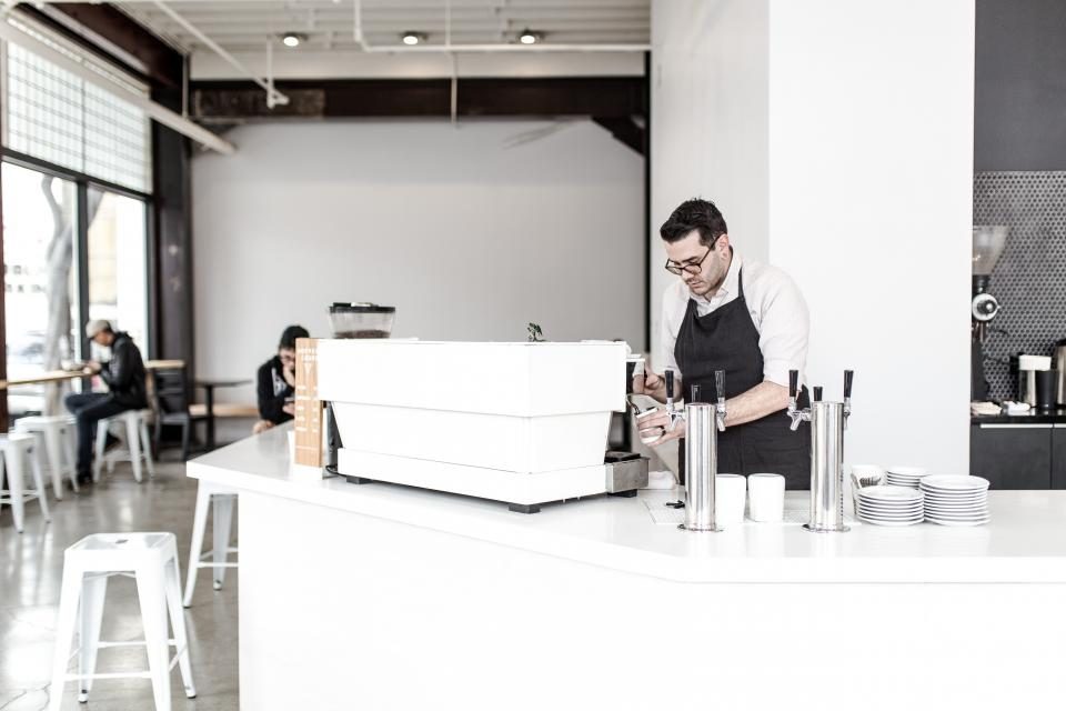 Barista serving in a bright café
